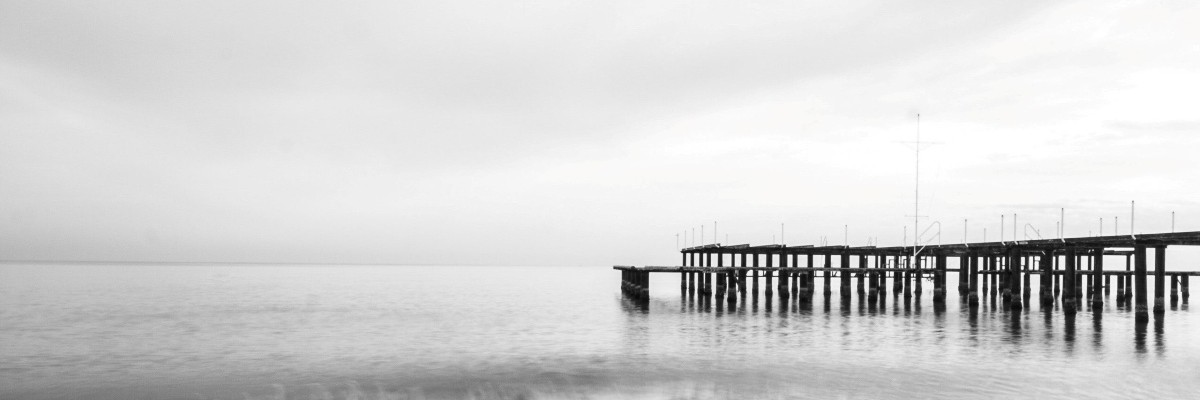 a large wood oceanside boat dock overlooking a bay